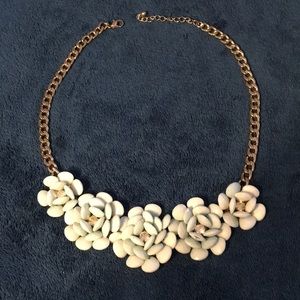 Flower cluster with diamond gem and gold necklace